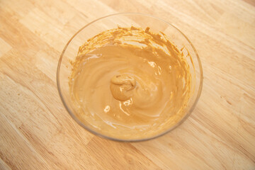 Creamy foam of Dalgona Coffee Latte on a bowl. Mixture of instant coffee and sugar.