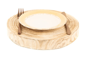 Empty plate with knife and fork on round wooden board isolated on white background.