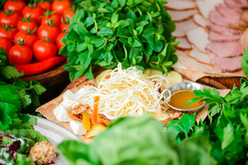 Traditional Georgian cheese on a wooden board. Cheese platter with sauces in Georgian. Suluguni, bryndza, mozarella.
