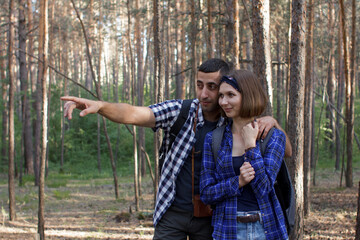 young couple for a walk in the spring forest