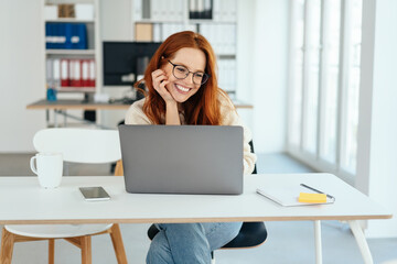 Happy smiling young businesswoman working