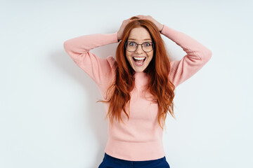 Delighted astonished young redhead woman