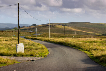 Fototapeta na wymiar Telegraph poles on a Welsh country road in the Brecon Beacons, South Wales, UK 