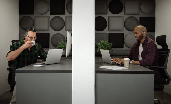 Businessmen Practicing Office Physical Distancing By Working In Separate Cubicles