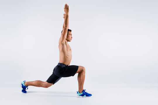Full length body size profile side view of his he nice attractive sportive guy doing sit-up rising hands up pose position shaping pilates yoga isolated over light white pastel color background