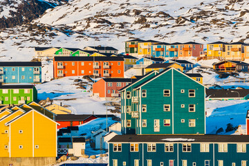 Colorful apartment buildings in winter landscape, Greenland
