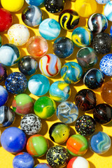 Colorful Marble Balls on Yellow background. Abstract Pattern