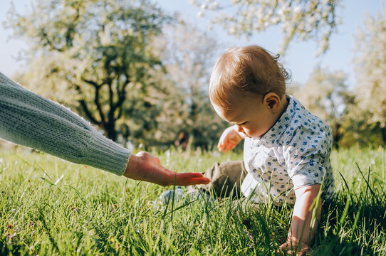 Beautiful young mother and child in the park. Happy mother's day. Helping children.