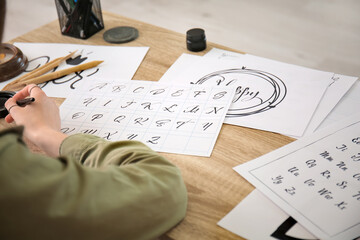 Female calligraphist working in office, closeup