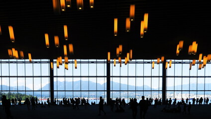 Many people in Vancouver Convention Center, viewing the beautiful landscape of North Vancouver