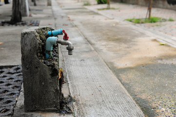 The pipe water supply is in concrete at the walkway of Asokaram temple in Samutprakarn province, Thailand