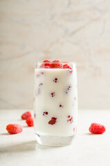 Milk with raspberry in the glass. Selective focus. Shallow depth of field.
