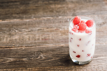 Milk with raspberry in the glass. Selective focus. Shallow depth of field.