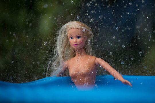 Mulhouse - France - 21 July 2020 - closeup of Barbie doll in the swimmingpool in the tropical rain