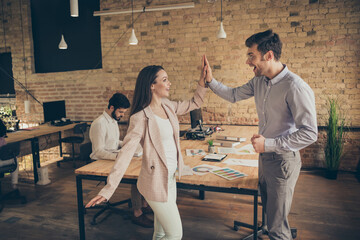 Yeah we did it. Photo of ecstatic woman man marketer achieve aim innovation anti crisis strategy plan progress deal investors partners hold hand hi-fi in modern workplace