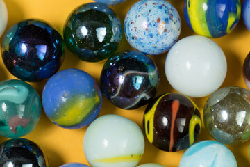 Colorful Marble Balls on Yellow background. Abstract Pattern