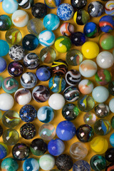 Fototapeta na wymiar Colorful Marble Balls on Yellow background. Abstract Pattern