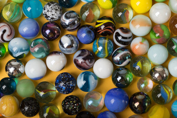 Colorful Marble Balls on Yellow background. Abstract Pattern