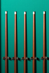 Billiard or Snooker Cue Sticks on Green Background