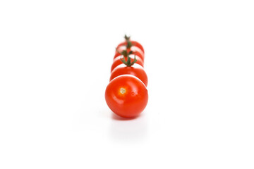 cherry tomatoes in a row on a white background