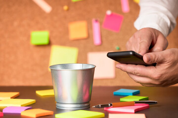 Businessman working with a smartphone along with notes