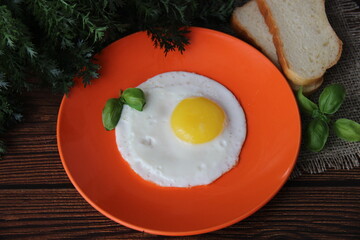 Fried chicken egg on an orange plate