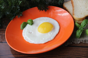 Fried chicken egg on an orange plate