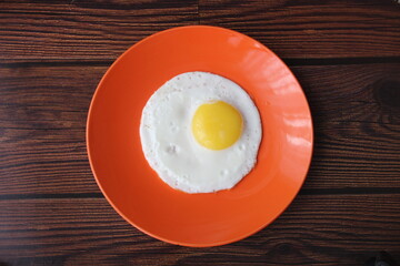 Fried chicken egg on an orange plate