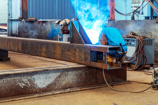 Workers at work, ongoing welding operation.