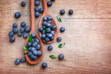 Wooden spoons with fresh ripe blueberries