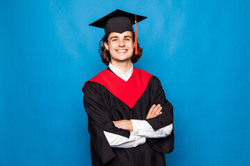 Young man with graduation diploma isolated on blue background