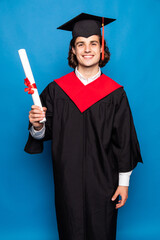 Young man with graduation diploma isolated on blue background