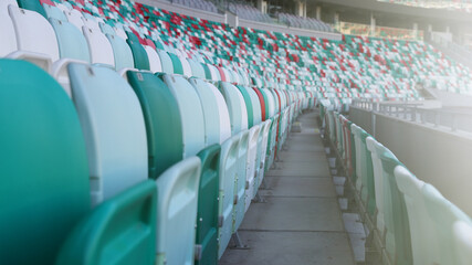Multicolored seats in a sports stadium. The seats for the fans