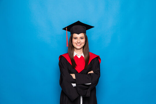 Young Woman In Graduation Robe Isolated On Blue Background