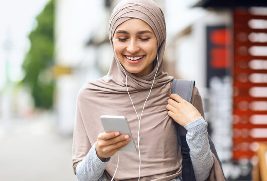 Laughing Girl In Hijab Watching Funny Content On Phone
