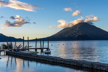 Morning view of the Atitlan volcano over the Atitlan lake in Panajachel with docks in the foreground