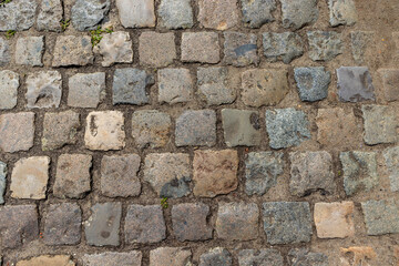 a pavement of grey and blue cobblestones
