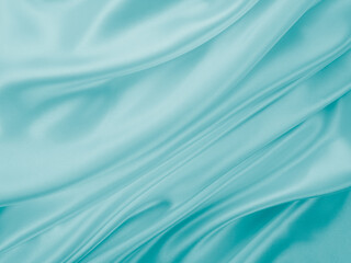 Beautiful elegant wavy turquoise silk or satin luxury cloth fabric texture, abstract background...
