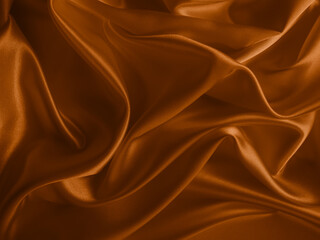 Beautiful elegant wavy brown satin silk luxury cloth fabric texture, abstract background design. Copy space.