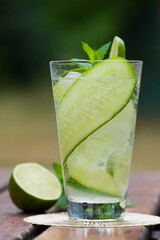 Refreshing drink - water with cucumber slices, ice cubes and fresh mint leaves.