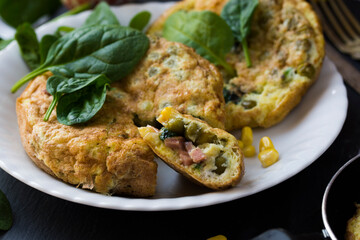An omelette with sweet corn, green peas and spinach.