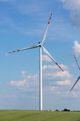 Fototapeta premium Wind farm, ecological windmills producing electricity without burning fuel