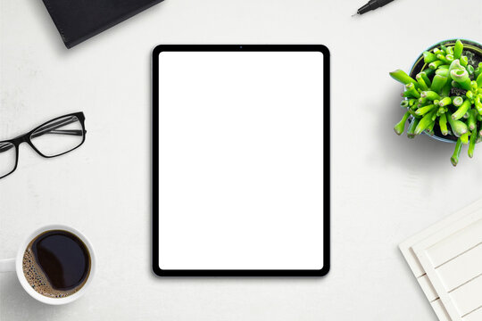 Tablet mockup on office desk. Isolated screen for app or web site design promotion. Top view, flat lay
