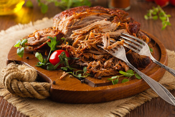 Pulled pork on a wooden board.