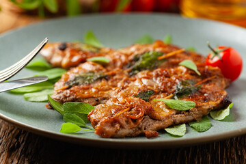 Saltimbocca. Veal schnitzel with sage and Parma ham. Italian specialty. Front view.