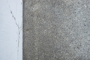 Street and white wall on the top, white painted cracked wall, gray asphalt street, empty and no people