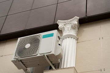 Gray air conditioner cooler on the building facade