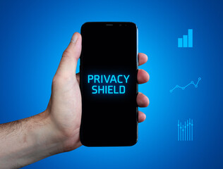 Privacy shield. Hand holds phone (cell phone). Word on display. Charts on blue background. Business