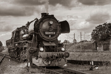 Fototapeta na wymiar Steam Locomotive, german Steam Locomotive, Steam Locomotive and big Clouds in Background, black and white photo