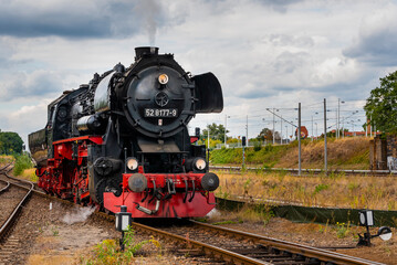 Fototapeta na wymiar Steam Locomotive, german Steam Locomotive, Steam Locomotive and big Clouds in Background